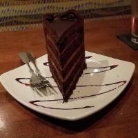 3 Layer Chocolate Cake · Dark chocolate cakes individually layered with chocolate mousse and glazed with a chocolate ...