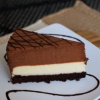 Double Decker Tuxedo Cake · Layers of chocolate cake, creamy Vanilla bean cheesecake, and velvety chocolate moose. Finis...