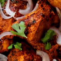 Chicken Tikka Kebab · Chicken pieces marinated in spices and yogurt and grilled and roasted in clay oven.