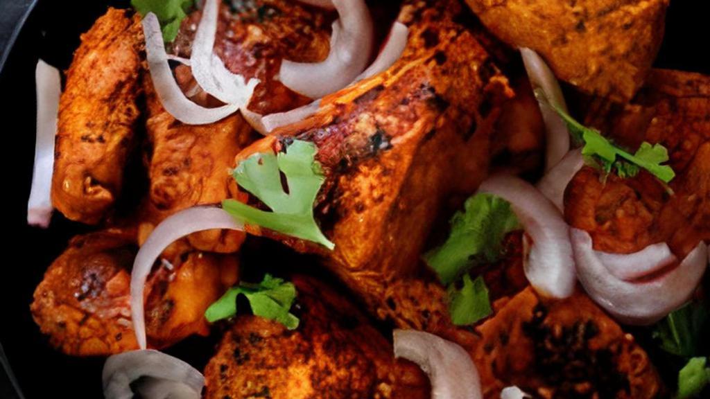 Chicken Tikka Kebab · Chicken pieces marinated in spices and yogurt and grilled and roasted in clay oven.