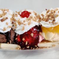 Banana Split (Traditional) · Served with Vanilla, Chocolate  and Strawberry ice creams, then covered with chocolate, pine...