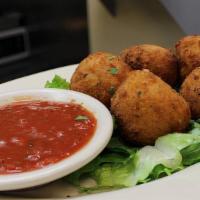 Arancini Di Riso Arborio (Rice Balls) · Risotto blended with grated romano cheese, breaded, deep-fried & served with our homemade ma...