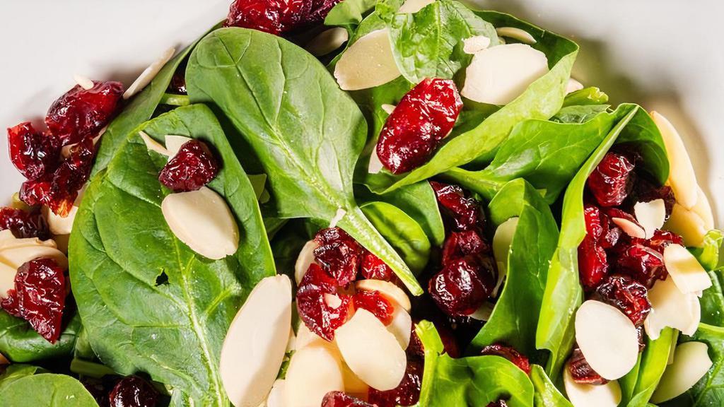 Cranberry Spinach Salad · Baby spinach, slivered almonds & dried cranberries served with our specially blended house balsamic dressing.