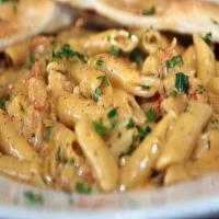 Crawfish Cajun Pasta · Alfredo sauce topped over penne noodles with cheese, red peppers and your choice of meat.
