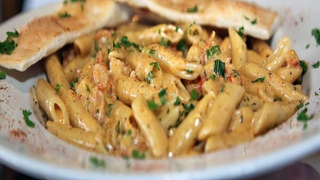 Crawfish Cajun Pasta · Alfredo sauce topped over penne noodles with cheese, red peppers and your choice of meat.