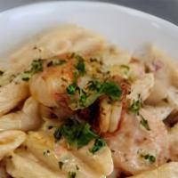 Shrimp Cajun Pasta · Alfredo sauce topped over penne noodles with cheese, red peppers and your choice of meat.