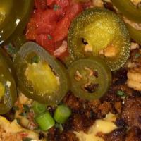 Obama-Chos · Nachos topped with cheese, hot sausage, crawfish tails tomato, green onion and jalapeños.