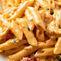 Chicken Cajun Pasta · Alfredo sauce topped over penne noodles with cheese, red peppers and your choice of meat.