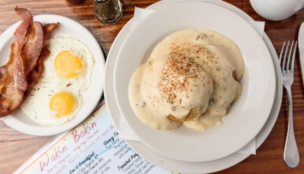 Biscuits & Gravy. · Two Honey Butter Biscuits smothered in our traditional sausage gravy, served with bacon &  two eggs