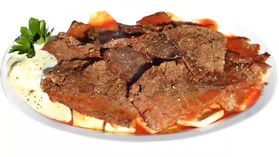 Iskender Kebab · Daily baked seitan doner kebab on pita slices, topped with tomato sauce and yogurt sauce.