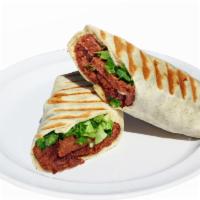 Doner Wrap · Vegan. Daily baked seitan doner kebab and tomato sauce in a white tortilla wrap.