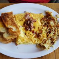 Mixed Grill Omelette · With ham, bacon, sausage, and American cheese. Served with your choice of one side and toast.