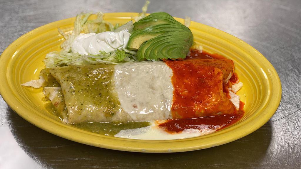 Burrito Bandera · Stuffed with steak, chicken, chorizo, rice, and black beans, then topped with avocado slices and smothered in three sauces: green tomatillo, creamy cheese sauce, and ranchero sauce (the colors of the Mexican flag). Served with lettuce, sour cream and pico de gallo.