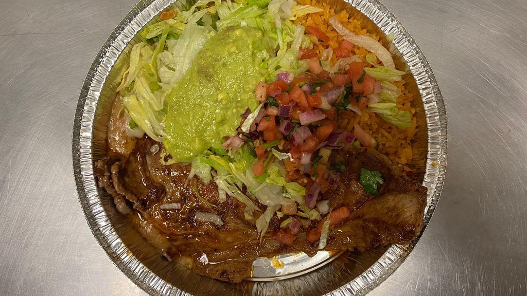 Carne Azada · Ribeye steak. Served with rice and beans, avocado, salad, corn or flour tortillas, topped with grilled onions.