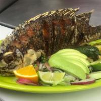 Mojarra Fried · The whole tilapia, fried and served with rice, beans, avocado salad, and tortillas.