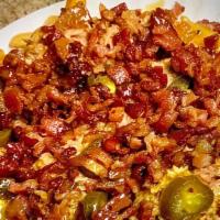 Monny'S House Fries · Generous portion of fries, topped with our pulled Chicken BBQ, cheese, bacon, jalapeños, and...