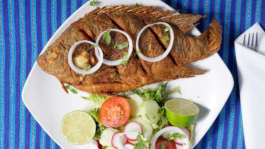 Mojarra Frita · Whole fresh fried tilapia cook to order. Served with rice, salad, and beans.