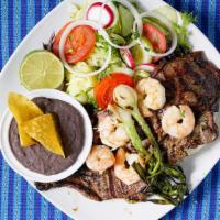 Tierra Y Mar · Choice of churrasquito or ribeye. Served with grilled shrimp, rice, salad, and beans.
