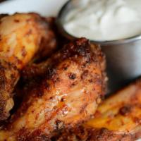 Smoked Wings · pecan wood smoked wings tossed in house rub served with choice of ranch or blue cheese dress...