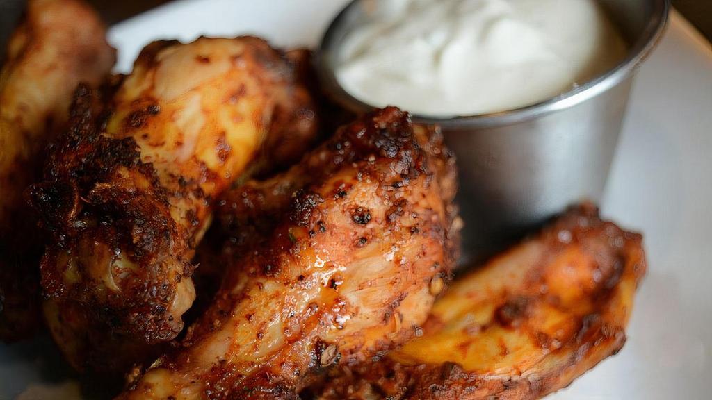 Smoked Wings · pecan wood smoked wings tossed in house rub served with choice of ranch or blue cheese dressing