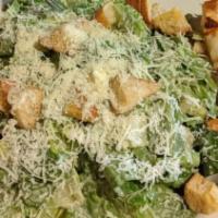 Caesar Salad · Romaine lettuce, tossed with a creamy Caesar dressing, croutons and shredded parmesan.