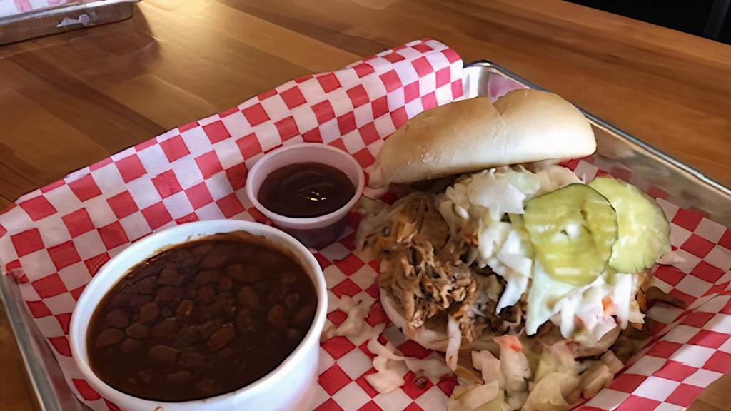 The Crazy Pig · Our Signature Sandwich. Pulled Pork on a Brioche Bun with pickles and homemade slaw.