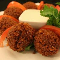 Falafel (6 Balls) · Ground chickpeas with onions, parsley, and garlic, then blended with special seasonings and ...