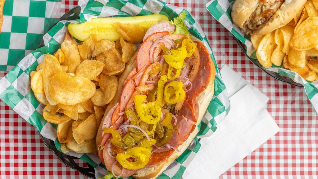 Italian · Capicola ham, Genoa salami, pepperoni, hot and sweet peppers, provolone cheese, lettuce, tomatoes, onions, and house dressing. All subs are prepared on a freshly baked roll and served with chips and a pickle.