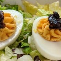 Little Devils · Deviled eggs topped with a spicy onion and pepper marmalade.