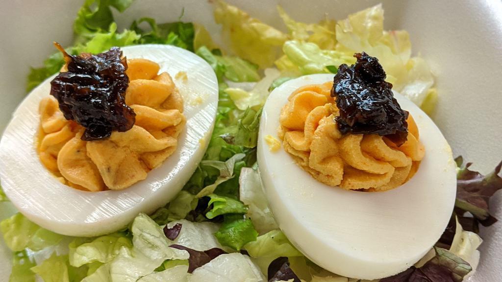 Little Devils · Deviled eggs topped with a spicy onion and pepper marmalade.