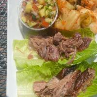 Maverick'S Bossam · Slow-cooked pork romaine wraps served with kim chee, pineapple pico de gallo, carrot & corn ...
