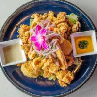 Jalea De Calamari · Crispy calamari accompanied by golden yuca, golden potato, tartar sauce and topped with crio...