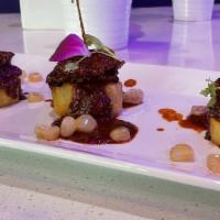 Filet Mignon Anticucho · Selected pieces of filet mignon laying in a mild spicy panca marinated sauce and skewed in a...