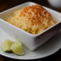 Esquite  · Fresh Elote (corn) in a cup.  The corn is topped with mayonnaise, then queso fresco and chil...