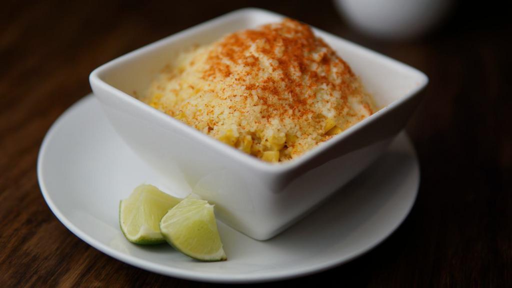 Esquite  · Fresh Elote (corn) in a cup.  The corn is topped with mayonnaise, then queso fresco and chile powder! It is also served very hot!