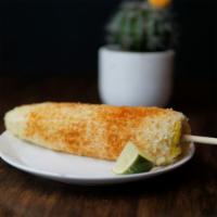 Elote Preparado · Fresh Elote (corn) on a cob, prepared with mayonnaise, queso fresco, and topped with chile p...