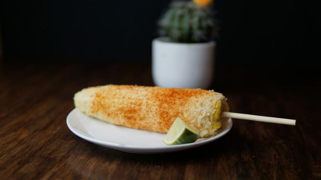 Elote Preparado · Fresh Elote (corn) on a cob, prepared with mayonnaise, queso fresco, and topped with chile power!