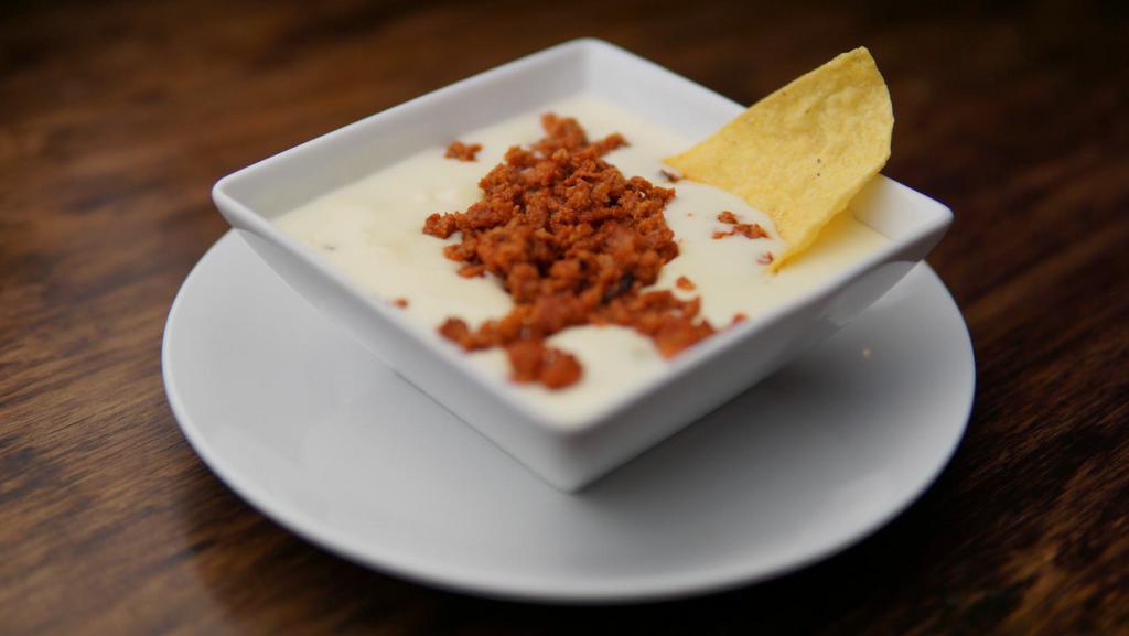 Choriqueso · What can be better than Cheese Dip? Well now we have choriqueso - Cheese Dip mixed with our homemade Chorizo (Mexican Sausage)! Each order comes with our fresh and hot Mexican Corn Tortilla Chips as well!