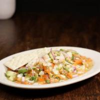 Ceviche · Raw shrimp marinated in lime juice mixed with cilantro cucumber, tomato, avocado, and diced ...