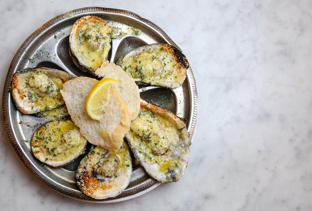 Charbroiled Oysters · Fresh, shucked oysters grilled over an open flame with butter, parmesan cheese and herbs. Served bubbling with french bread.