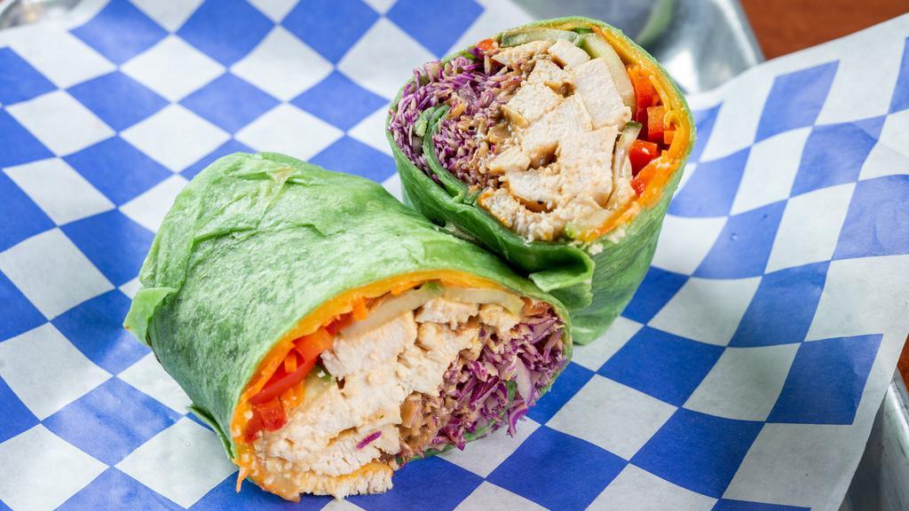 Thai Peanut Wrap · Grilled chicken OR tofu, Thai peanut sauce, sriracha, red cabbage, cucumber, carrot, red pepper, cheddar cheese on a spinach wrap