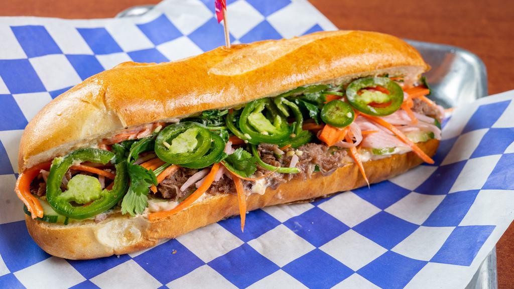 The Banh You · Shaved sirloin OR “No Evil Foods” plant meat. cucumbers, fresh jalapeños, Cilantro, Quick pickled vegetables, 5-spice aioli on a hoagie roll.