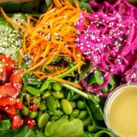 Asian Salad · Spinach topped with cucumber, pickled cabbage, red pepper, carrot, edamame, sesame seeds wit...
