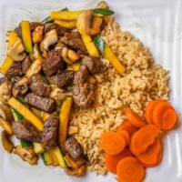Hibachi Steak · Grilled with zucchini and mushrooms in a ginger soy sauce. Served over Japanese fried rice a...