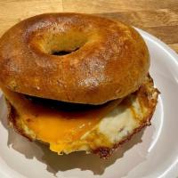 The Griddler · Fried Egg, american cheese and sausage with maple syrup drizzle on a specialty bagel