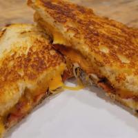 Ultimate Grilled Cheese · Cheddar, american, mozzarella cheese and bacon served on sourdough