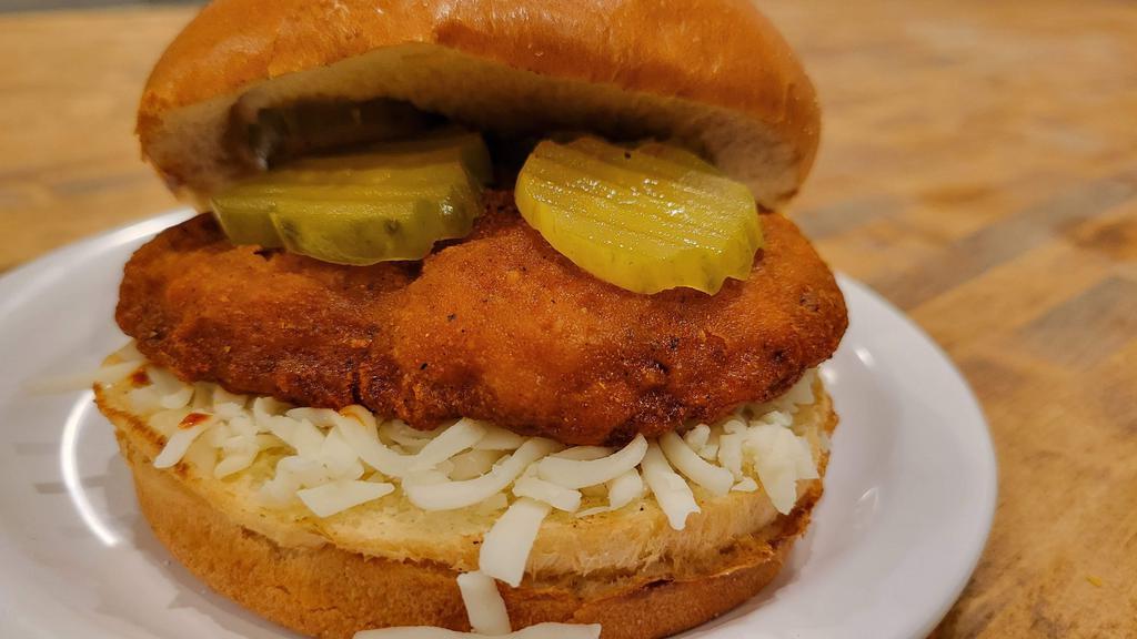 Hot Chicken · fried chicken seasoned with our Nashville hot chicken seasoning, topped with mozzarella and pickles on a brioche bun with a side of ranch