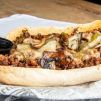 Philly Cheesesteak Sandwich · Thinly-sliced grilled steak tossed with onions, bell peppers, and sliced mushrooms with swis...