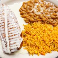 Chimichanga Dinner · Fajita chicken, steak, or both topped with cheese sauce, served with rice, beans, lettuce, g...