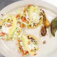 Tacos De Pescado  · Homemade corn tortilla tacos with tilapia, fresh onions, cilantro & cabbage, served with whi...